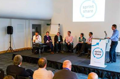 panel of 6 people sitting on stage answering questions