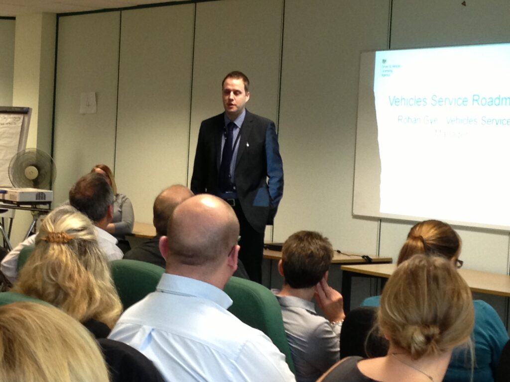 Rohan Gye standing in front of a screen presenting an overview of DVLA’s strategy 