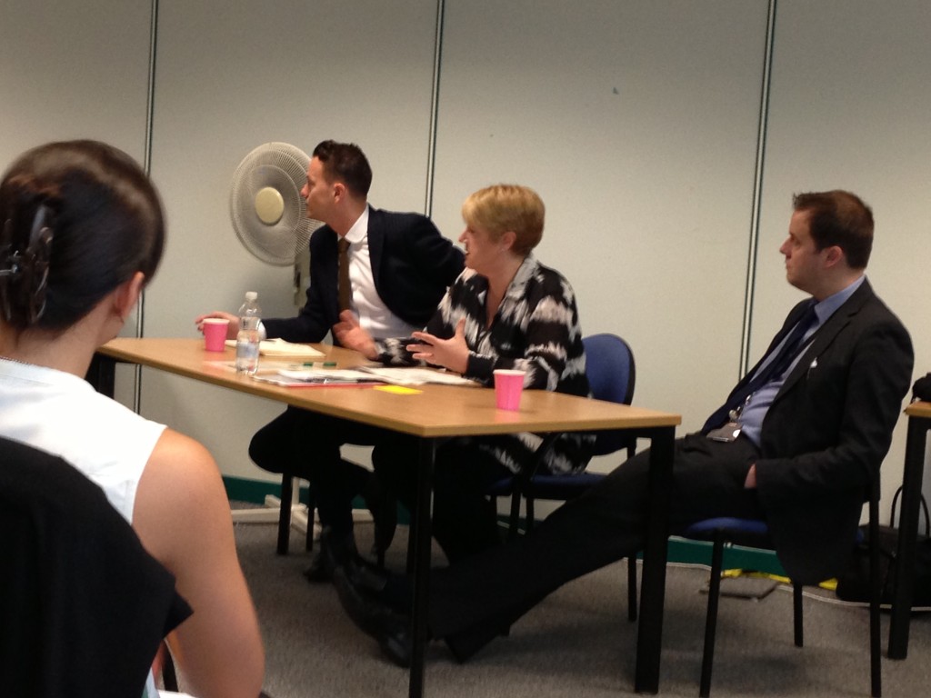 Ross, Julie and Rohan sitting at a table answering questions from stakeholders