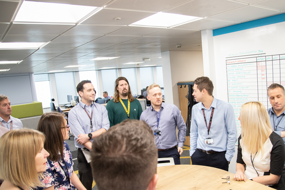 Team meeting around a table to discuss the service 