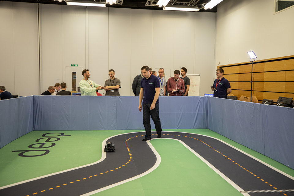 Race track with a man racing a toy car