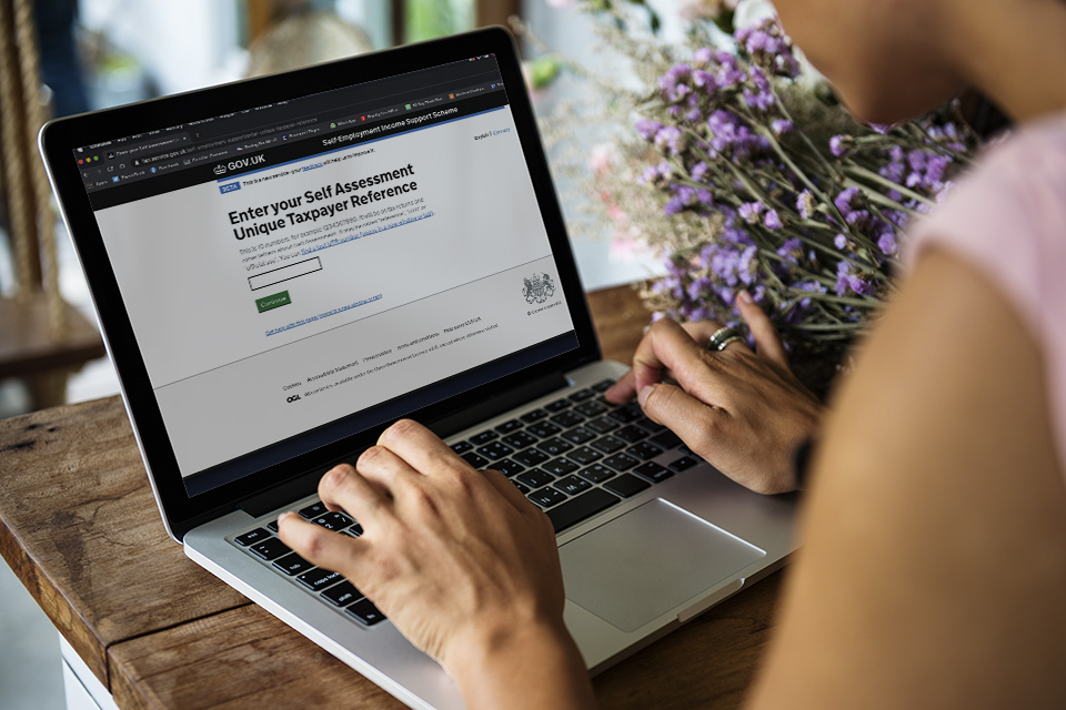 Woman looking at the Self-employment Income Support Scheme on her laptop